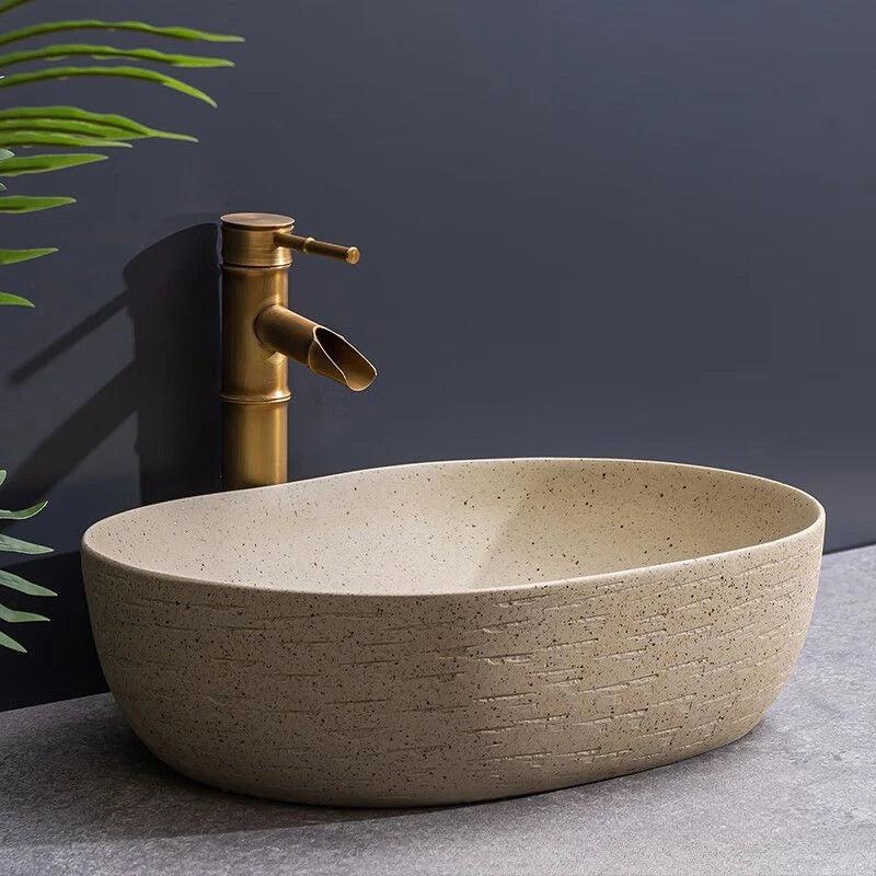 Norda Oval — Lavabo de encimera de cerámica efecto piedra