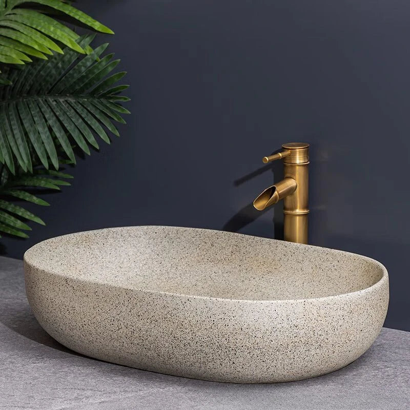 Norda Oval — Lavabo de encimera de cerámica efecto piedra