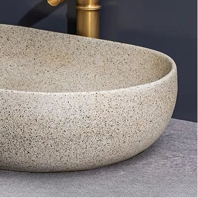 Norda Oval — Lavabo de encimera de cerámica efecto piedra